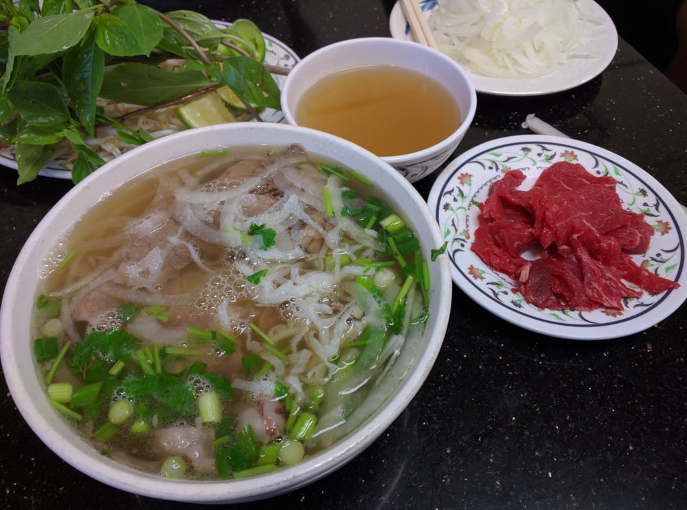 Pho with a side plate of thin raw beef and a cup of broth