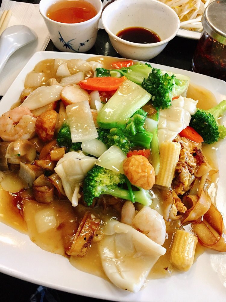 Seafood and vegetable stir-fry over crispy noodles