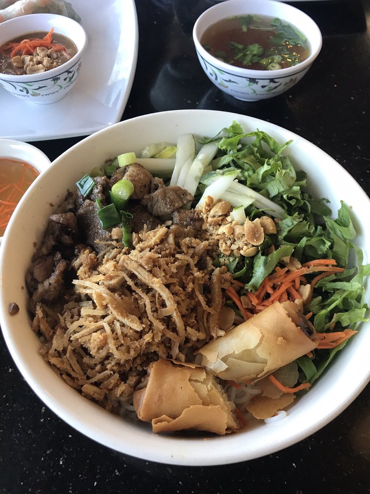 Vermicelli bowl with grilled pork, egg roll, herbs and peanuts